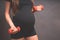 Young pregnant woman exercises with red fitball and dumbell.