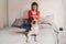young pregnant woman at home with her beagle dog