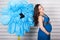 Young pregnant woman with huge blue flower