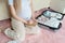 Young Pregnant woman packing suitcase for maternity hospital at home, closeup. Checklist for childbirth. Pregnancy during