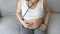 Young pregnant woman putting stethoscope on tummy, healthcare and pregnancy care concept