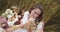 Young pregnant woman relaxing during picnic in a wheat field