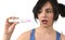 Young pregnant woman scared in shock checking pink positive result on pregnancy test