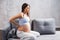 Young pregnant woman suffers from back pain. Pregnancy, motherhood, health care and lifestyle concept.