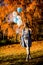 Young pregnant woman walks in autumn park with balloons in hand