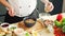 Young prepares a poke bowl in a modern kitchen. The man prepares food at home. Cooking healthy food.