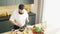 Young prepares a poke bowl in a modern kitchen. The man prepares food at home. Cooking healthy food.