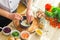 Young prepares a poke bowl in a modern kitchen. The man prepares food at home. Cooking healthy and tasty food.