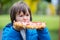 Young preschool child, boy, eating salty bread with cheese and k