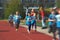 Young preschool children, running on track in a marathon competition