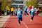 Young preschool children, running on track in a marathon competition