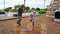 Young preschooler kids boy and girl jump on brown stumps