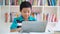 Young preteen boy studying with laptop