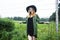 Young pretty blond woman in hipster hat posing in fashion dress outside in green country rancho, lifestyle people