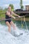 Young pretty blond woman learning to ride wakeboard