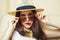 Young pretty brunette girl wearing hat and sunglasses waiting alone at home, lifestyle people concept