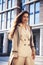 Young pretty brunette woman in fashion suit at buseness building posing cheerful, lifestyle people concept