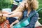 Young pretty curly hippie couple with guitar outdoor