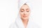 Young pretty cute girl with towel on her head and closed eyes