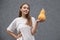 Young pretty European woman wearing white t-shirt, prepares for special holiday, holding ripe pumpkin