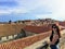 A young pretty female tourist posing on top of the Walls of Dubrovnik overlooking the old town of Dubrovnik, Croatia