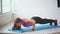 A young and pretty fitness trainer does push-ups from the floor in a sports club