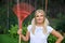 Young pretty gardening woman with rakes