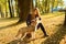 Young pretty girl is training and feeding off the hands of red haired husky puppy