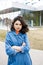 Young pretty girl walking on the street, dressed in jeans and denim shirt. Student weekdays