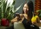 Young pretty and happy Asian Chinese woman sitting relaxed at coffee shop or hotel restaurant using social media internet app on