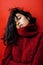 Young pretty indian mulatto girl in red sweater posing emotional, fashion hipster teenage, lifestyle people concept