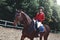 Young pretty jockey girl preparing horse for ride. love horses. girl riding a horse