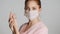 Young pretty nurse in medical mask washing hands on camera isolated. Safety first concept
