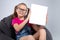 Young pretty school girl holding white book