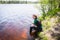 Young pretty slim brunette woman in wetsuit riding wakeboard on