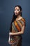 young pretty south asian girl posing in studio on grey background, lifestyle people concept