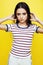 Young pretty teenage woman emotional posing on yellow background, fashion lifestyle people concept
