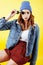 Young pretty teenage woman emotional posing on yellow background, fashion lifestyle people concept