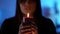 young pretty witch is telling fortune by flame of candle, closeup portrait in darkness