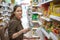 Young pretty woman chooses healthy and quality products in the supermarket