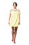Young pretty woman in fluttering yellow short dress walking and looking at camera