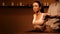 Young pretty woman has Thai massage at luxury spa. Warm inviting colors, calm atmosphere, charming light.