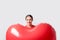 Young pretty woman holding a heart shaped air balloon. Valentine`s day concept