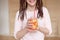 Young pretty woman holding mason jar with lemonade.