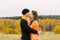 A young pretty woman hugs her boyfriend in the fall outdoors. Lovers walk in the Park. Cute lovers in the Park. The family concept