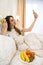 Young  pretty  woman lay on the bed  using her smartphone to relax after hard work week