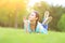 Young pretty woman lying on grass at summer sunset. Natural happiness, fun and harmony.