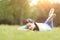 Young pretty woman lying on the grass at summer sunset. Natural happiness, fun harmony.