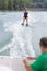 Young pretty woman riding wakeboard on wave