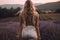 Young pretty woman standing back on the lavender field